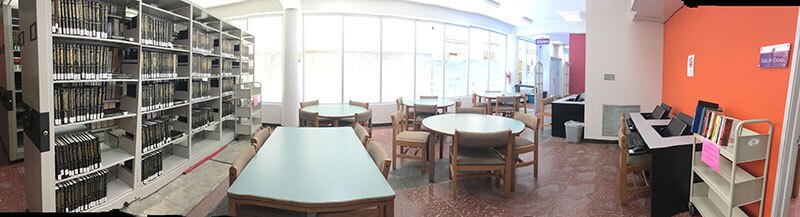 library-mi wide angle of albizu university with tables and book shelves