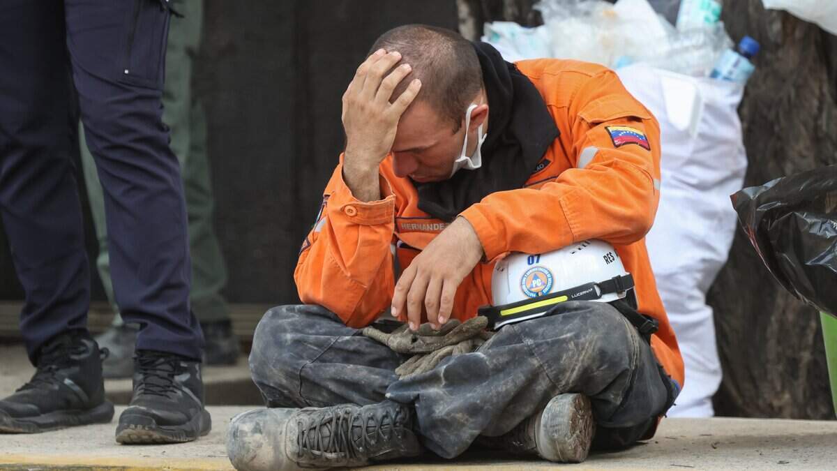CARACAS, VENEZUELA - JUNE 25: A Civil Protection worker sits after a magnitude 7.2 earthquake struck Venezuela and other regions in the Caribbean on June 25, 2026 in Caracas, Venezuela. According to the U.S. Geological Survey (USGS), the main earthquake was followed by a 7.5-magnitude aftershock less than a minute later. The number of victims increased to 164 and over a thousand injured. (Photo by Edilzon Gamez/Getty Images)